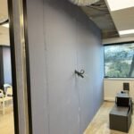 Cloison en plaques de plâtre en cours de montage et faux plafond ouvert, chantier de bureaux Aktive à Sophia Antipolis
